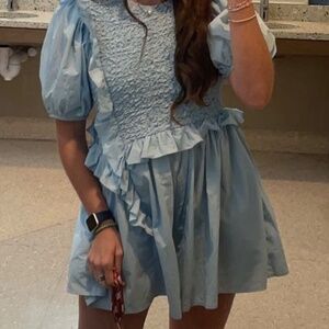 Light blue smocked romper with ruffle trim 